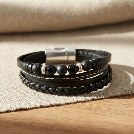 Bracelet manchette horizons boutique en cuir noir tressé et lisse, avec perles d'onyx, de lave et fermoir magnétique argenté.