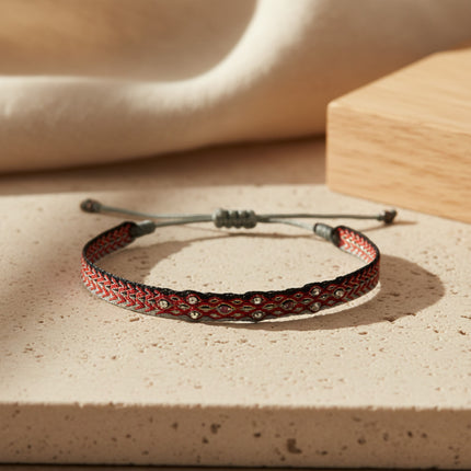 Bracelet tissé main horizons boutique en fils de polyester rouge et noir, orné de petites billes argentées et de tourmalines roses.